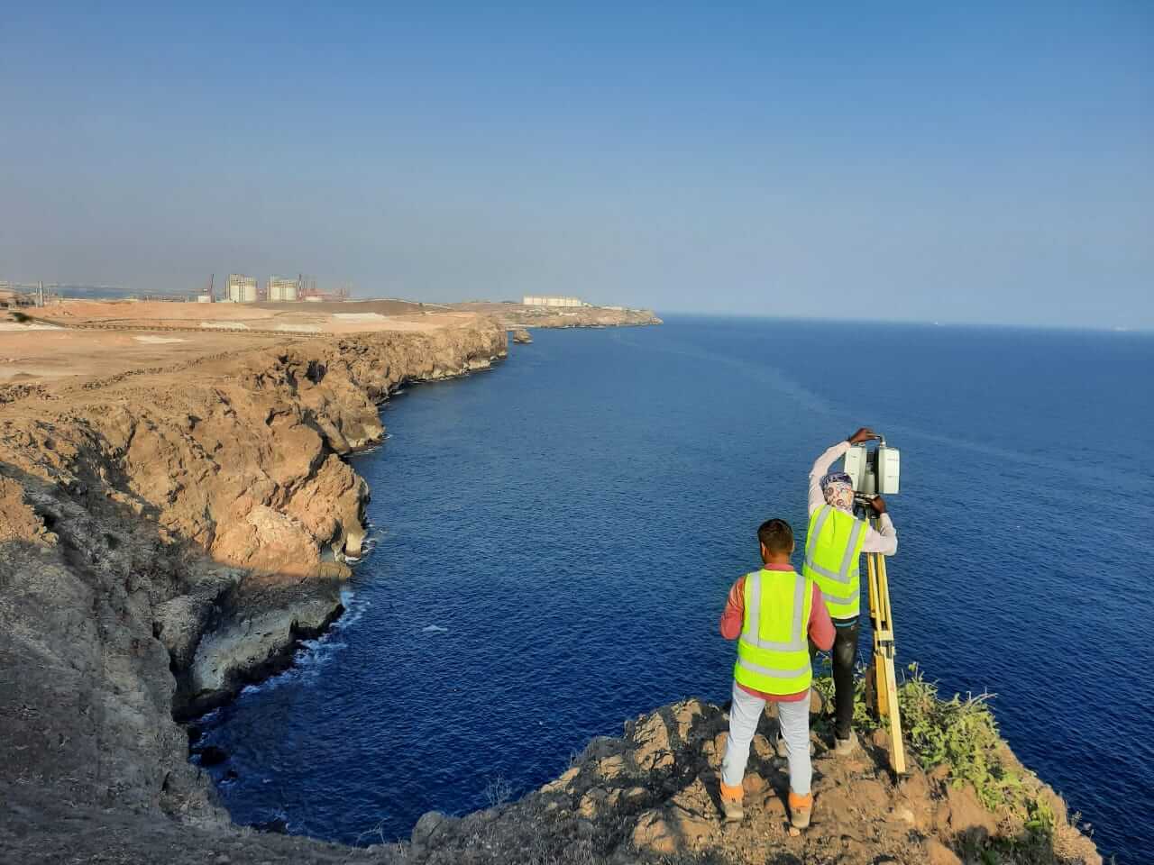 Al Warqa Survey Engineering field team with Leica P40 scanner on a cliff edge overlooking the sea