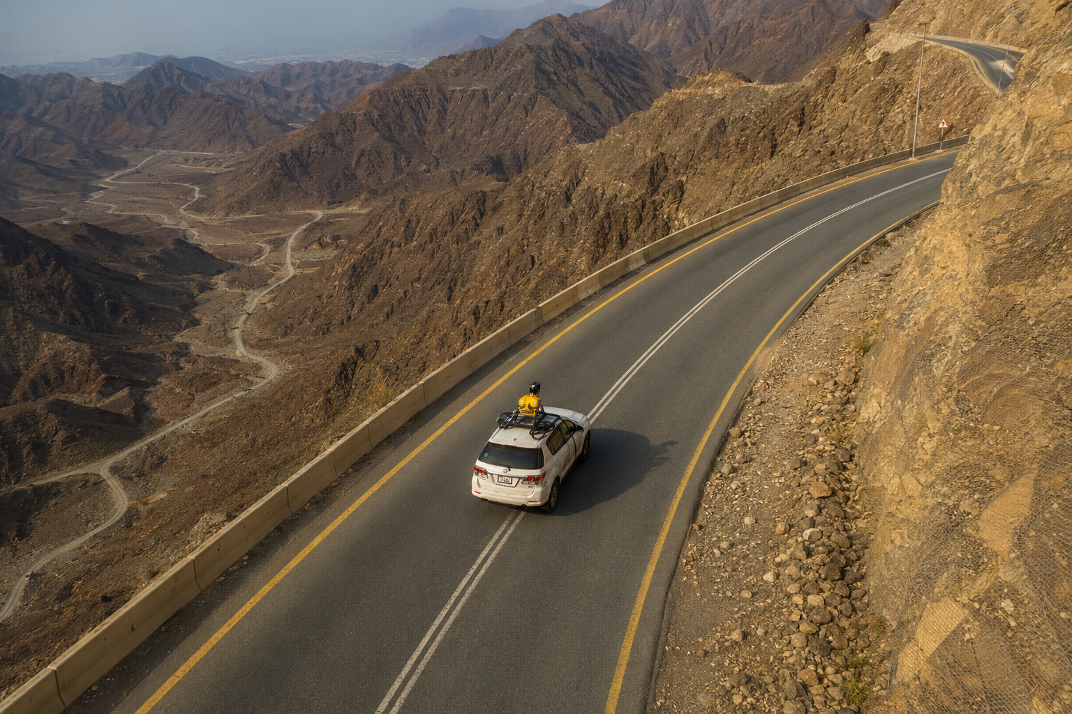 Mobile LiDAR mapping vehicle on a mountain road corridor in the UAE